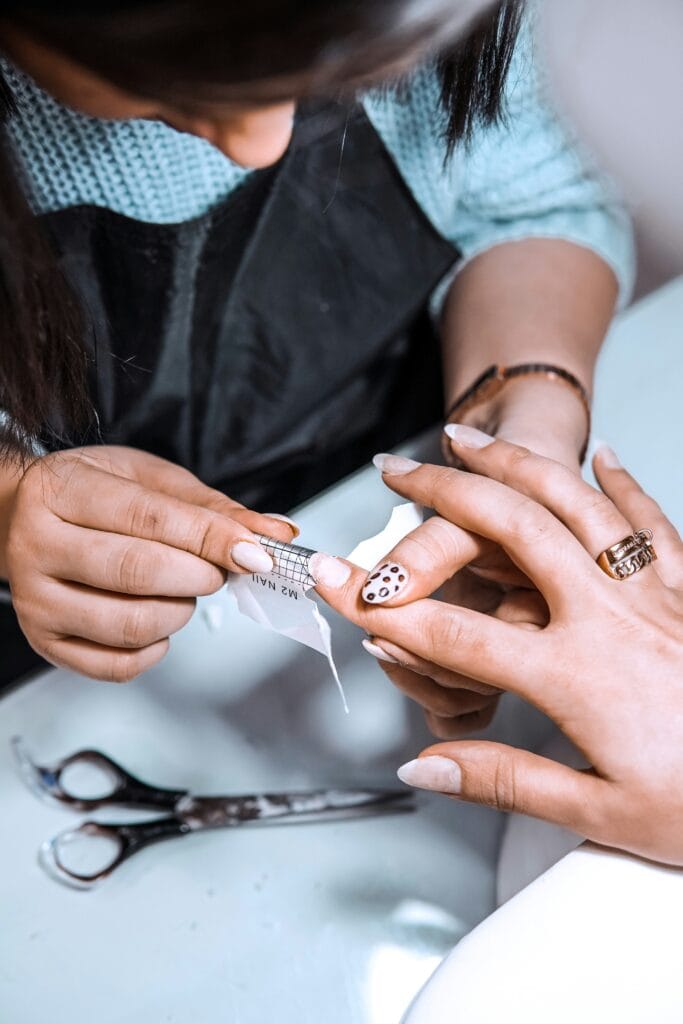 Woman examining her nails and hands, early sign of collagen decline, natural skin and nail support supplement concept