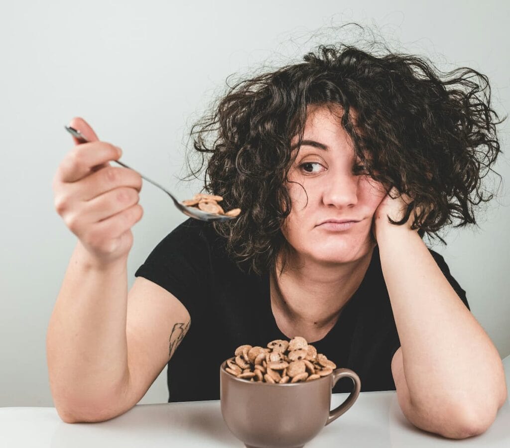 Woman feeling sluggish and bloated after a heavy meal, early sign of liver health changes, natural liver support supplement concept