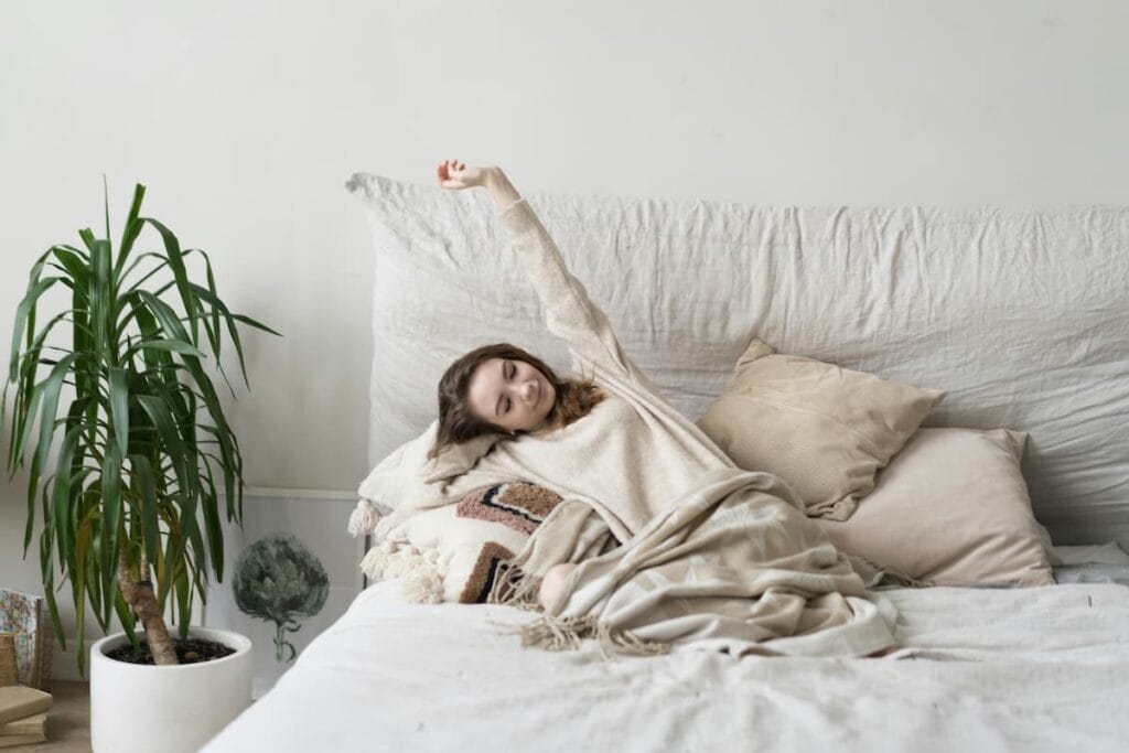 Woman doing gentle morning stretches at home, healthy habit to support joint mobility
