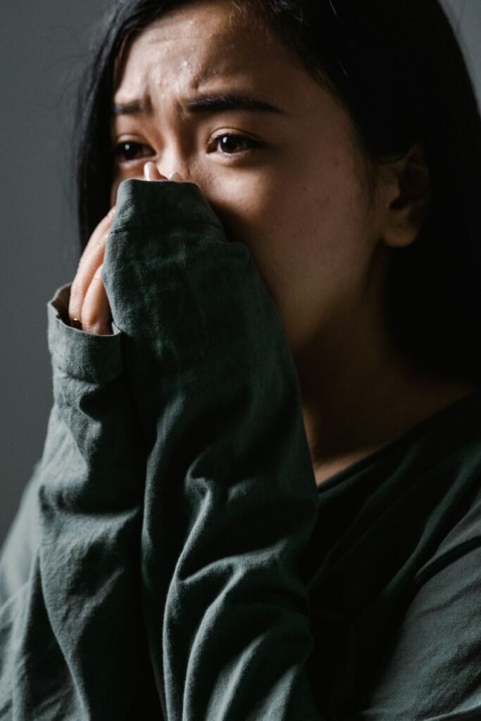 Close-up of a distressed woman indoors showing anxiety and stress